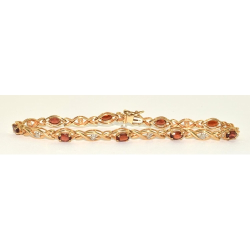 318 - 9ct gold Diamond and Garnet fancy twist bracelet 19cm long