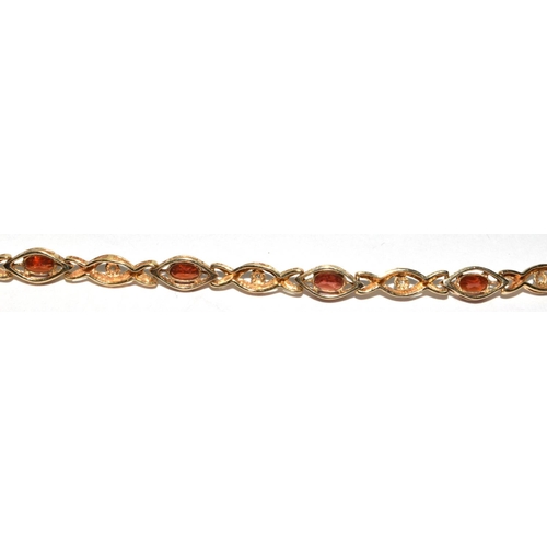 318 - 9ct gold Diamond and Garnet fancy twist bracelet 19cm long