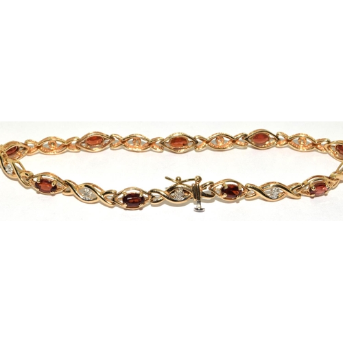 318 - 9ct gold Diamond and Garnet fancy twist bracelet 19cm long