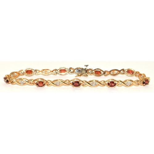 318 - 9ct gold Diamond and Garnet fancy twist bracelet 19cm long