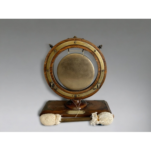 511 - A 19th century gilt porthole mirror, together with a Victorian dinner gong and painted wood corbel.