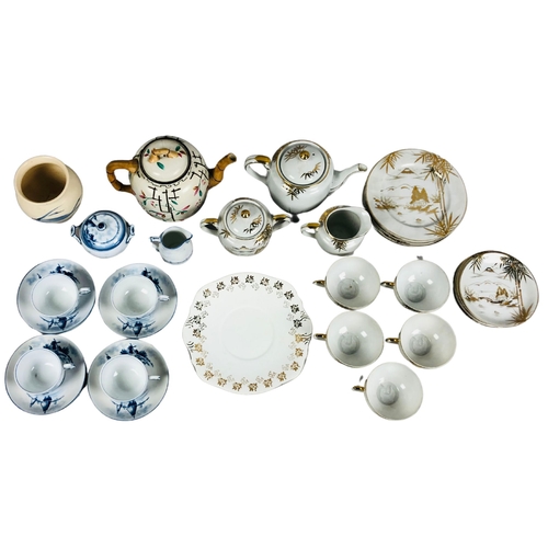 22 - A fine porcelain Japanese part tea set  together with a teapot with faux bamboo handle and spout and... 