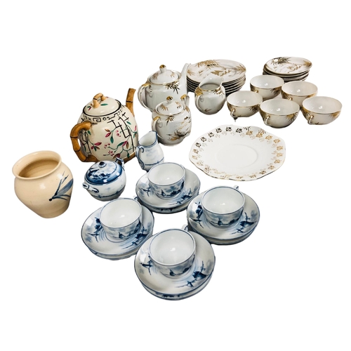 22 - A fine porcelain Japanese part tea set  together with a teapot with faux bamboo handle and spout and... 