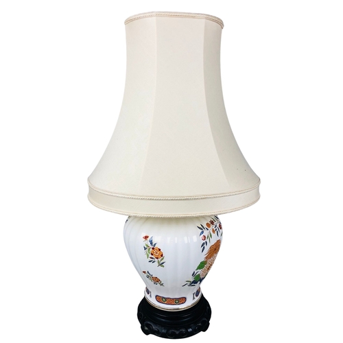 113 - Large Oriental style lamp on carved wooden base.71cm tallbase