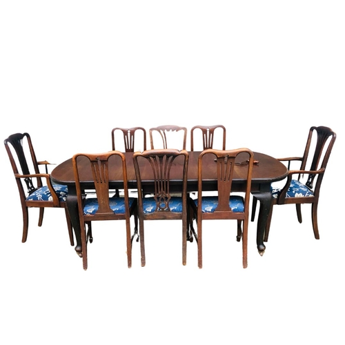 138 - A mahogany wind out dining table with one leaf insert. Complete with winder. Six Chairs and Two Carv... 