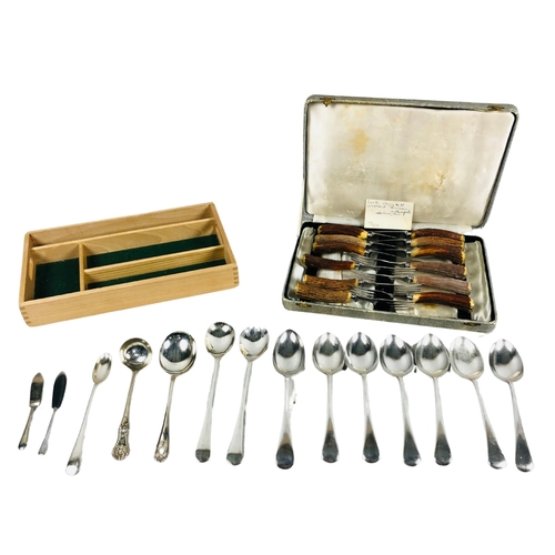 102 - A boxed set of 12 horn handled knives and forks together with various items of flatware and a cutler... 