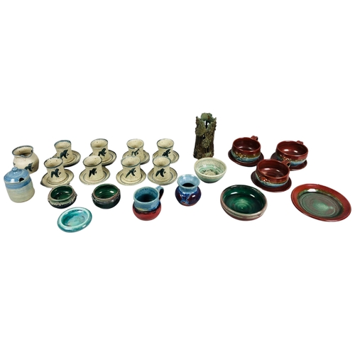 103 - Various items of Studio Pottery to include a set of 8 cups and saucers.