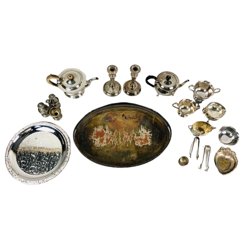 114 - Large assortment of silver plate items to include teapots, bowls and candlesticks.