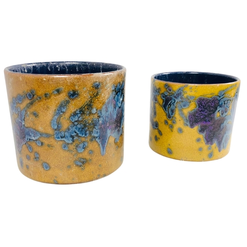 119 - Pair of studio pottery pots with a mustard yellow base and blue/purple splash decoration