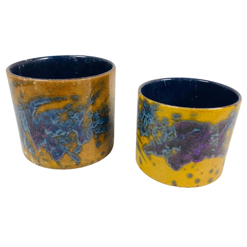 119 - Pair of studio pottery pots with a mustard yellow base and blue/purple splash decoration