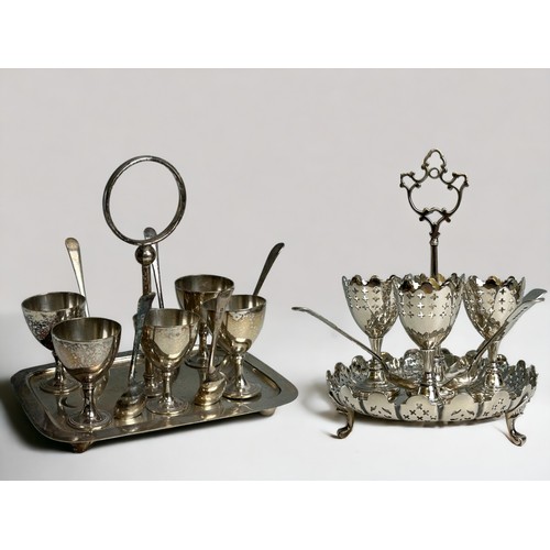 514 - Two Victorian silver plate egg cup cruet sets.