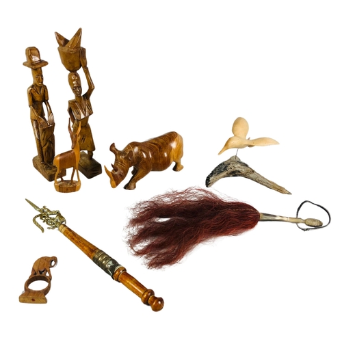 128 - Assortment of carved wood objects to include carvings of a man and a woman and a fly whisk.