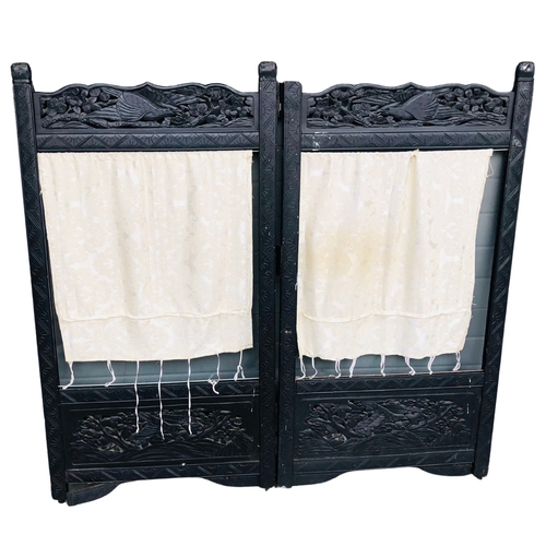 144 - Heavily carved vintage 2 panel screen in the oriental style.