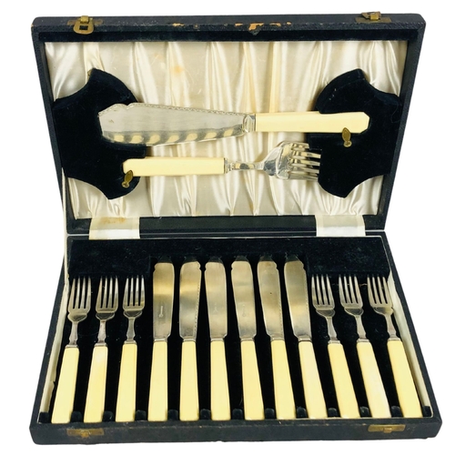 153 - Boxed set of fish Knives and forks complete with servers in the lid.