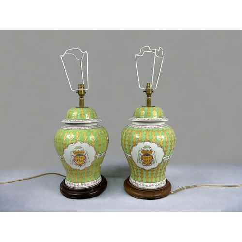 17 - A large pair of Chinese Armorial porcelain table lamps.Hand painted green & gold ground with Coa... 