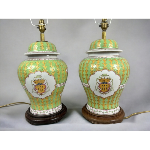 17 - A large pair of Chinese Armorial porcelain table lamps.Hand painted green & gold ground with Coa... 