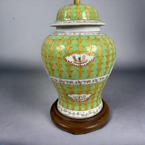 17 - A large pair of Chinese Armorial porcelain table lamps.Hand painted green & gold ground with Coa... 