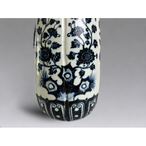 27 - A Chinese porcelain Ming style vase.20th Century. Heaped & piled cobalt design with applied leaf... 