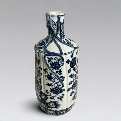 27 - A Chinese porcelain Ming style vase.20th Century. Heaped & piled cobalt design with applied leaf... 