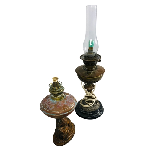 229 - Antique Copper oil lamp bases together with one chimney and one spare chimney