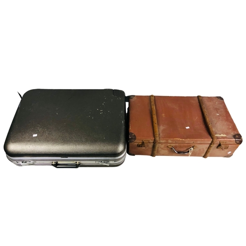 253 - Hard shell Delsey Suitcase together with a vintage suitcase.