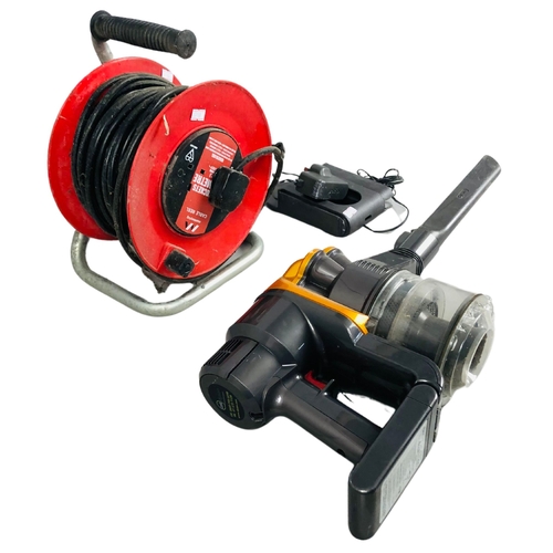 259 - Extension Cord on Reel and Dyson handheld rechargeable vacuum.