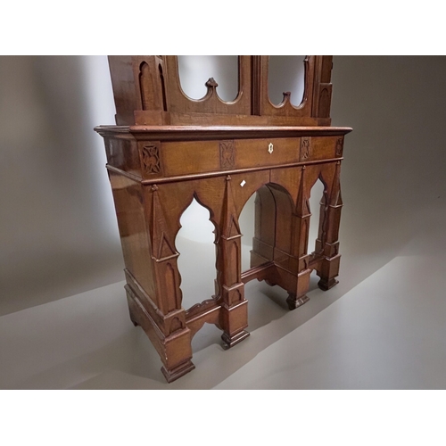 369 - A carved Walnut gothic Biedermeier / cupboard.With central pull-out writing drawer.Twin mirrored doo... 