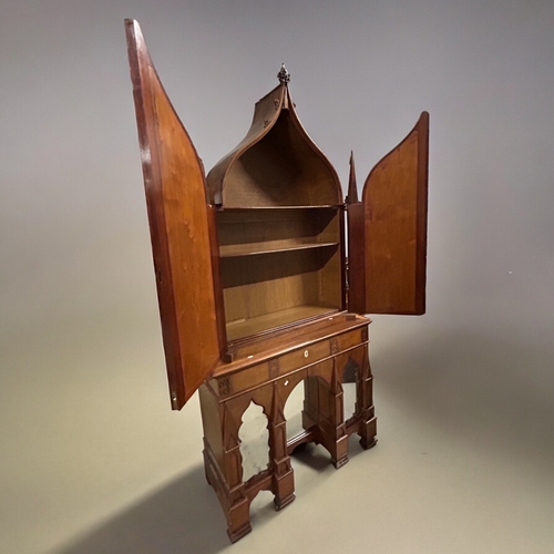 369 - A carved Walnut gothic Biedermeier / cupboard.With central pull-out writing drawer.Twin mirrored doo... 