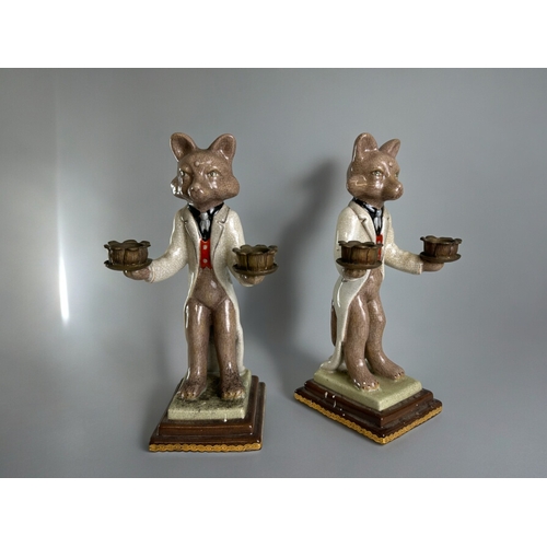 765 - A pair of hand painted porcelain 'Fox' candlesticks.With gilt metal holders.Height - 27cm... 