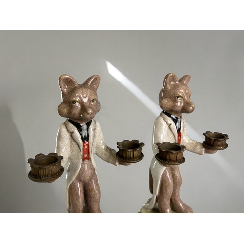 765 - A pair of hand painted porcelain 'Fox' candlesticks.With gilt metal holders.Height - 27cm... 