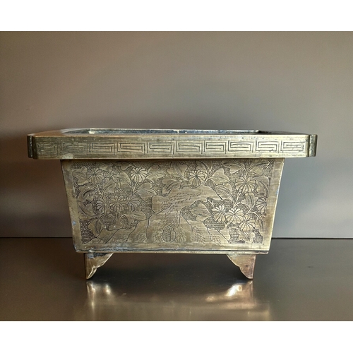 771 - A Chinese chased bronze planter.Late Qing / Republic period.Rectangular form, with chased outcrops t... 