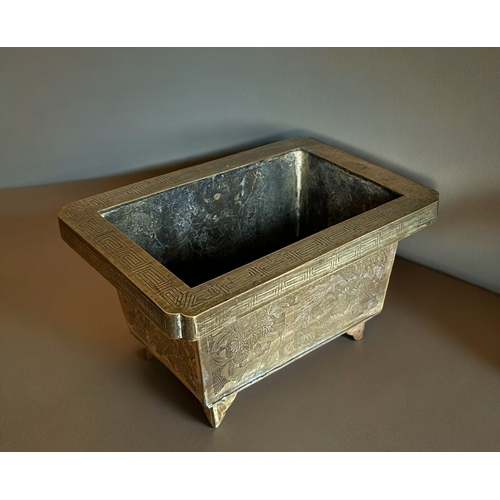 771 - A Chinese chased bronze planter.Late Qing / Republic period.Rectangular form, with chased outcrops t... 