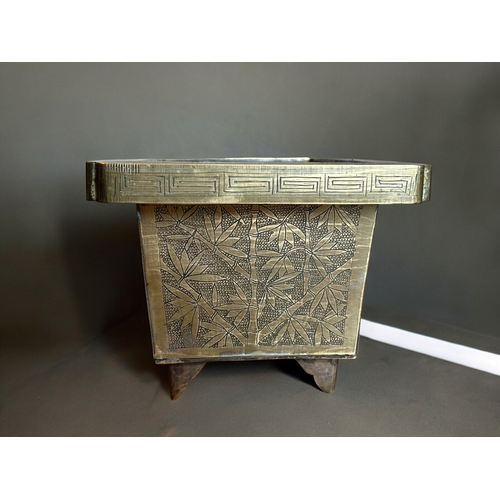 771 - A Chinese chased bronze planter.Late Qing / Republic period.Rectangular form, with chased outcrops t... 