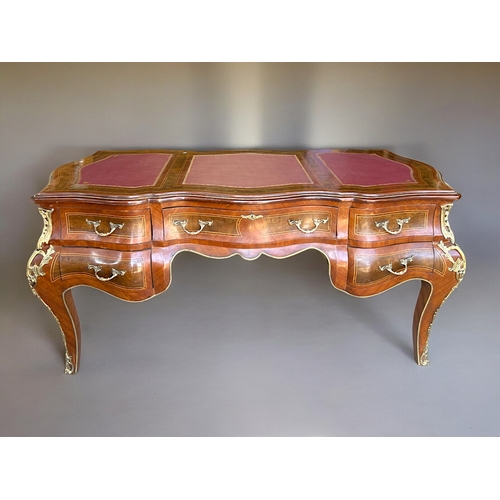 797 - A large French Empire style Bombe bureau plat / writing desk.Drawers to one side with dummy drawers ... 