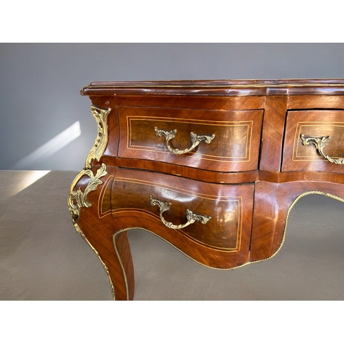 797 - A large French Empire style Bombe bureau plat / writing desk.Drawers to one side with dummy drawers ... 