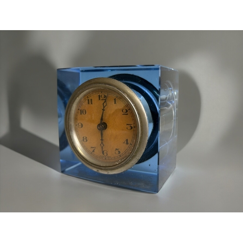 203 - A Blue glass Art Deco desk clock. Together with a French brass travel clock.Glass clock height - 8cm... 