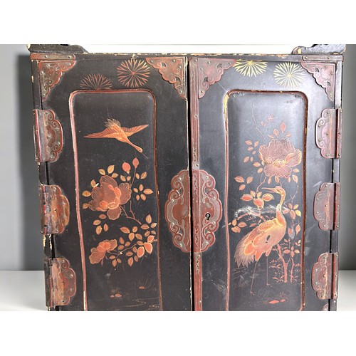 96 - A Japanese lacquer dresser cabinet.Meiji period.Twin doors open to reveal four drawers.37cm x 29cm x... 