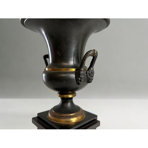 453 - A 19th century Grand Tour patinated garniture.Mounted on slate pillar.Height - 30cm