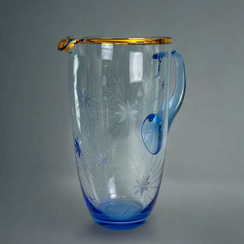 343 - A vintage blue glass etched Starburst pattern pitcher & five glasses.Jug height - 23cm