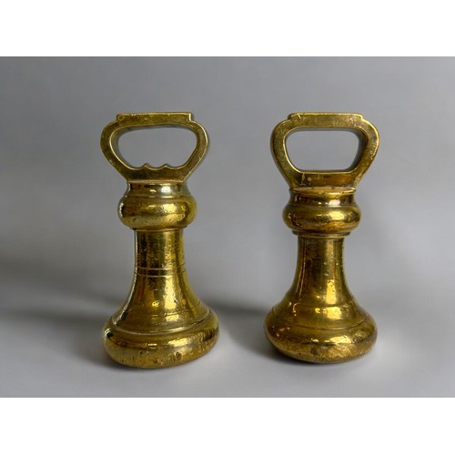 122 - Pair of antique Avery brass 7lb grocers weights.Height - 18.5cm