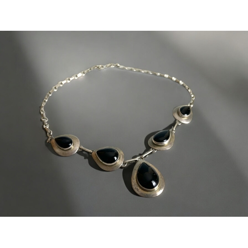 436 - A sterling silver & Onyx ladies Parure.Set includes necklace, bracelet, ring and earrings.