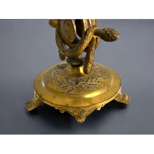 457 - A French Ferdinand Barbedienne gilt bronze watch holder & candlestick.19th century.Decorated wit... 