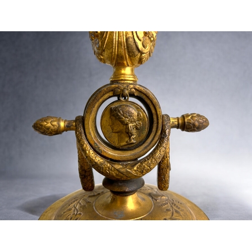 457 - A French Ferdinand Barbedienne gilt bronze watch holder & candlestick.19th century.Decorated wit... 