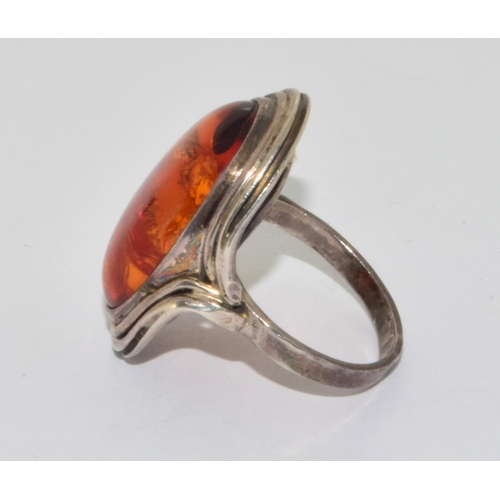 243 - 925 silver vintage Amber statement ring in an oval setting with scroll edging size O