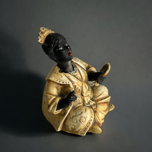 409 - A late 19th century German porcelain nodder doll.Parody English Colonial Rule Indian Princess.Probab... 