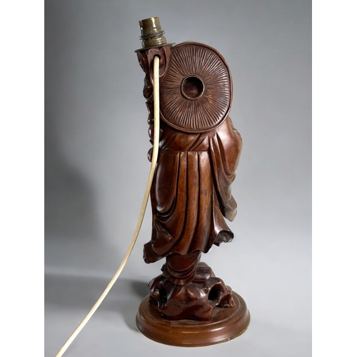 138 - A Chinese carved rootwood Luohan figural lamp.Holding captive bat.Height - 42cm