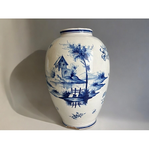 486 - A large Delft blue & white vase.18th / 19th century.Tin glazed, hand painted lakeside scenes.Mar... 