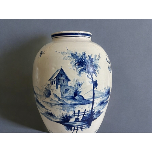 486 - A large Delft blue & white vase.18th / 19th century.Tin glazed, hand painted lakeside scenes.Mar... 