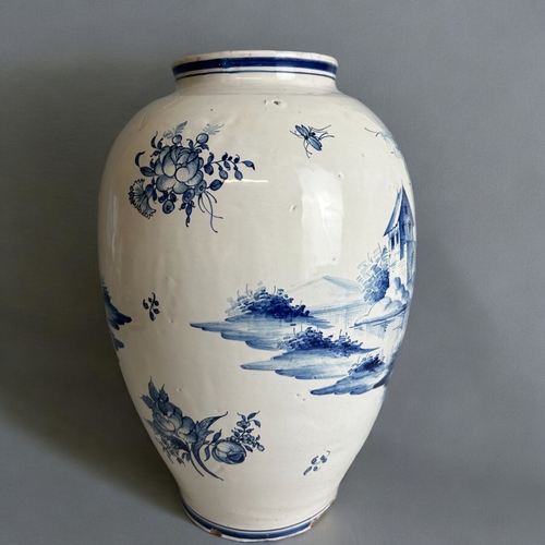 486 - A large Delft blue & white vase.18th / 19th century.Tin glazed, hand painted lakeside scenes.Mar... 