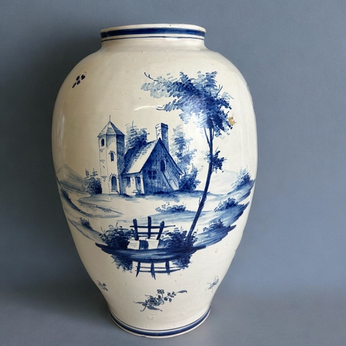 486 - A large Delft blue & white vase.18th / 19th century.Tin glazed, hand painted lakeside scenes.Mar... 